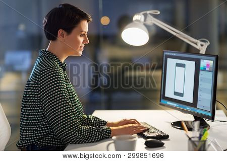 business, design and technology concept - female graphic designer with computer working at night office