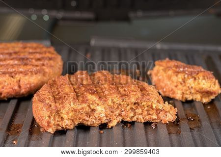 Close Shot Of The Meat Like Plant-based Patties For Vegetarian Beef Burgers Being Grilled On Hot Gri