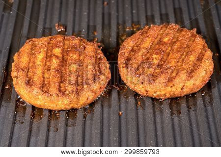 Close Shot Of The Meat Like Plant-based Patties For Vegetarian Beef Burgers Being Grilled On Hot Gri