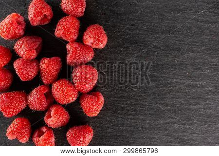 Lot Of Whole Fresh Red Raspberry With Copyspace Flatlay On Grey Stone