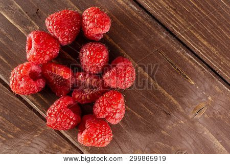 Lot Of Whole Fresh Red Raspberry With Copyspace Flatlay On Brown Wood