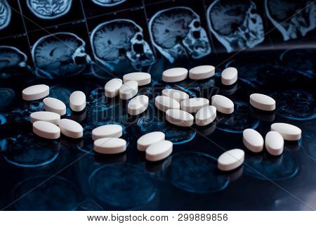 White Pharmaceutical Medicine Pills On Magnetic Brain Resonance Scan Mri Background. Pharmacy Theme,
