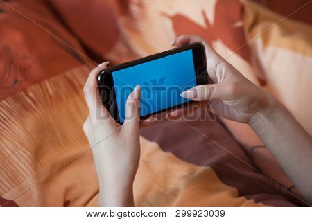 Saint-Petersburg / Russian Federation - 27 March 2019: Female hand with manicure holding cellphone with VK