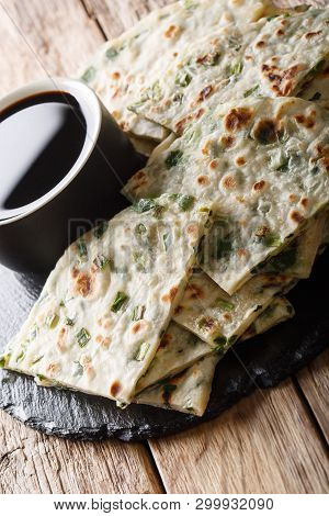 Vegan Scallion Pancakes Are A Crispy Pan-fried Chinese Flatbread Close-up On A Board. Vertical