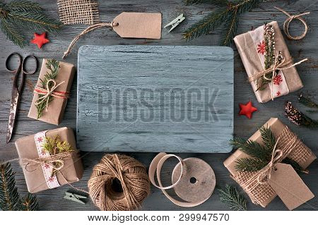 Seasonal Background From Above. Hand Crafted Gifts On Rustic Wooden Table With Christmas Decorations