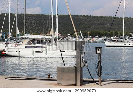Fuel Distributor On The Pier Of A Gas Station In The Mediterranean Marina Against The Backdrop Of Sa