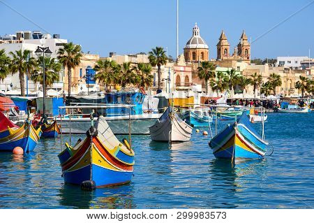 Marxaslokk Harbor With Traditional Maltese Eyed Boats - Luzzu On The Bright Sunny Day.