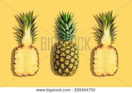 Fresh Pineapples On Yellow Background. Creative Suumer Concept.