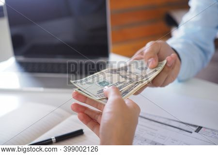 People Holding Money To Pay Interest To Bank Employees. Pay Cash