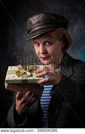 A Man Accepts A Long-awaited Gift In A Beautiful Package. A Cardboard Box With A Surprise Inside.