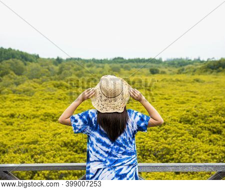 Asian Traveler Woman Holding The Hat And Standing On Wooden Bridge For Travel At Tung Prong Thong Fo