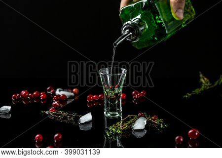 Alcohol, Luxurious Spirits And Dangerous Liquor Absinthe, Pouring, Green Bottle Of Strong Spirit.