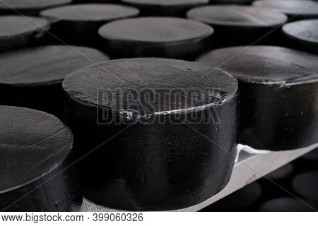 Loops Of Black Milk Goat Cheese In A Factory Warehouse. Long-term Maturation Of Cheese In A Special