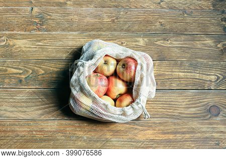 Organic Apples In Reusable Eco Friendly Mesh Bag On The Wooden Background. Package-free Food Shoppin