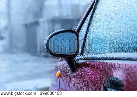 Car Side-view Mirror Froze After Freezing Rain. Abnormal Weather, Freezing Rain Covered The Red Car 