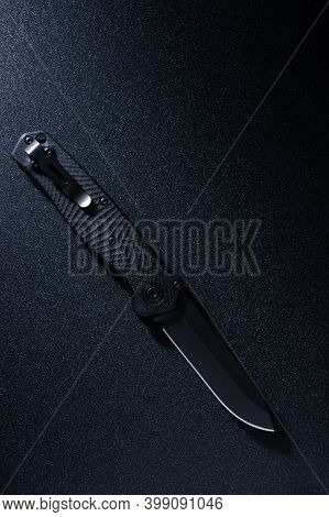 Knife With Black Blade And Handle. A Knife With A Shiny Edge.