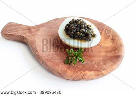 A Quail Egg With Black Caviar On