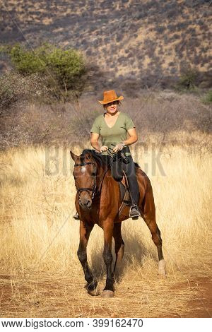 Blonde Horsewoman Rides Towards Camera In Savannah