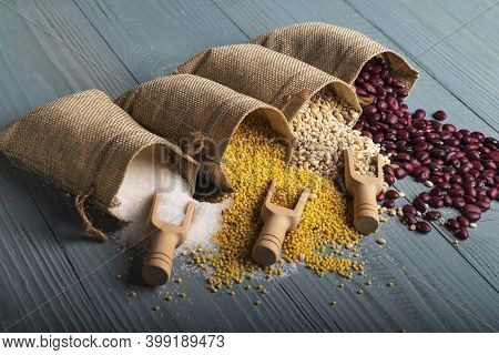Studio Lighting. Retro Style Wooden Background. There Are Cereals On It. Red Beans, Millet, Pearl Ba