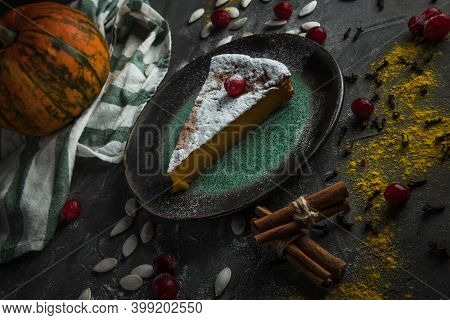 Beautiful Piece Of Pumpkin Pie With Cranberries And Powdered Sugar On A Stone Table. Nearby Are Pump