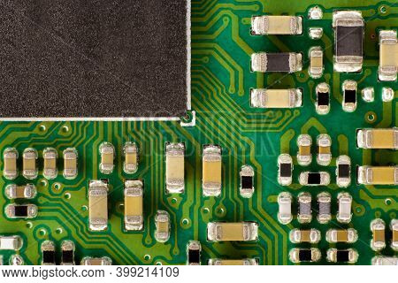 A Green Electrical Board Containing A Black Microprocessor And Various Electrical Components Connect