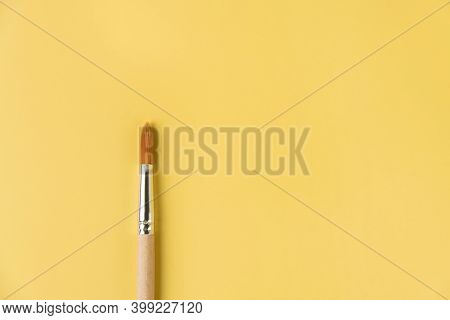 Brush For Painting On A Yellow Isolated Background. Top View