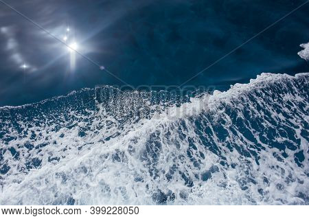 Blue Sea Water. There Is A Wave On It.