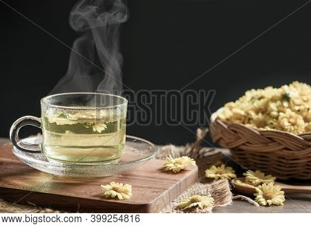 Chrysanthemum Tea With Hot Steam And Chrysanthemum Flower In Basket On Black Background. Healthy Bev