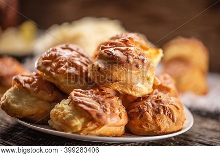 Slovak Pagace, Serbian Or Croatian Pogace, Or Hungarian Pagacsa Crispy Bread Buns Stacked On A Plate