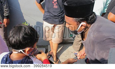 Jakarta, Indonesia - 12-04-2020: One Small Child And One Adult Who Are Doing Qobul Consent For Qurba