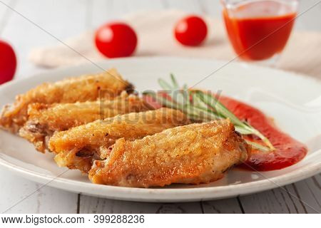 Buffolo Wings Close-up With Tomato Sauce And Tomatoes