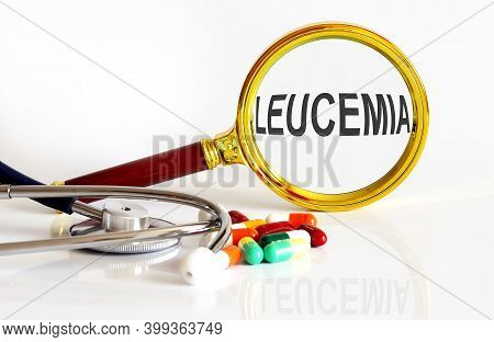 Magnifying Lens With Text Leucemia With Medical Tools,pills