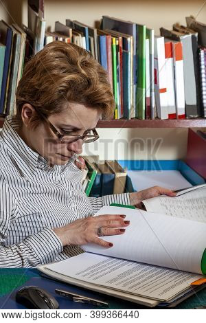 Image Of A Busy Woman Telecommuting At Her Desk At The Home. Working At Home Became An Important Rec