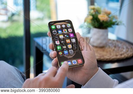 Alanya, Turkey - December 6, 2020: Man Hand Holding Iphone 12 Pro Max Gold With Home Screen Ios 14 O