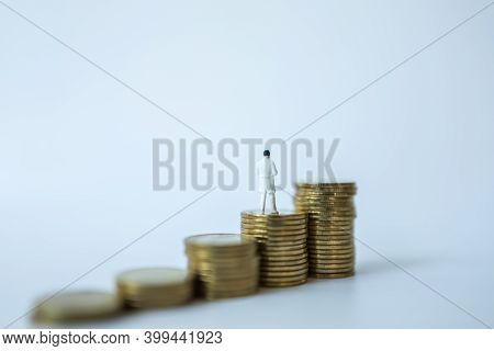 Business And Healthcare Concept. Docter Miniature Figure People Standing On Top Of Stack Of Coins On