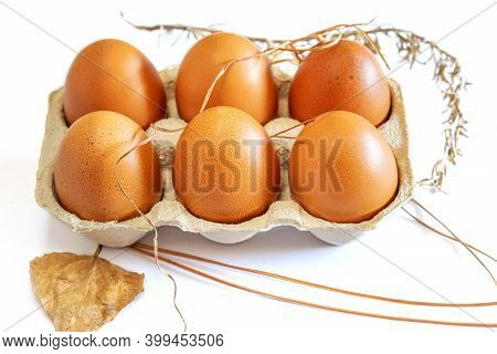 Fresh Brown Eggs In Conteiner On The White Background.