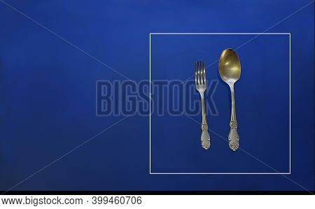 Spoon And Fork In A Frame On A Blue Background. Road Sign Concept.