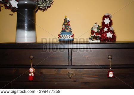 Wooden Cabinet With Christmas Decorations And Christmas Muggle Carousel. High Quality Photo
