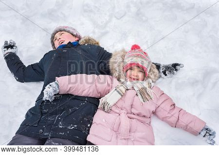 Children Play Outdoors In Winter. Winter Vacation