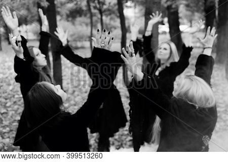 Coven Of Witches, A Group Of Friends As Witches On Halloween Perform A Ritual, Lead A Round Dance An
