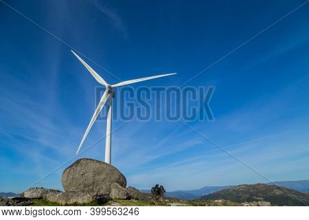 Wind turbine generator on top a hill for the production of clean and renewable energy near Fafe, Portugal