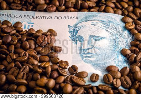 Coffee From Brazil, With Brazilian Money In The Background. Concept Of High Quality Coffee For Expor