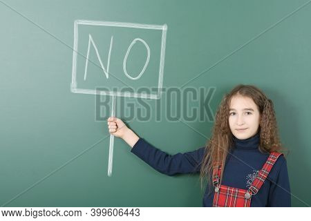 Pre-adolescent Girl Holding Painted Tablet With The Inscription 