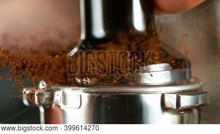 coffee machine preparing fresh coffee. Close-up of mill grounding beans.