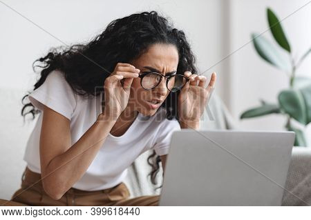 Young Woman Freelancer With Bad Eyesight Using Laptop, Using Glasses, Home Interior, Copy Space. Cur