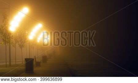 Lanterns On The Street Of The Night City In The Fog.