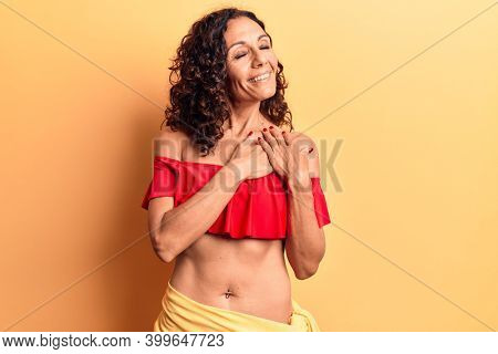 Middle age beautiful woman wearing bikini smiling with hands on chest, eyes closed with grateful gesture on face. health concept. 