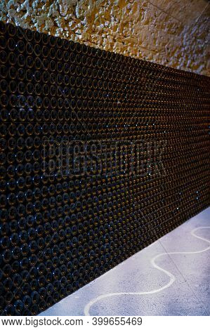 Champagne Grand Cru Sparkling Wine Production In Bottles In Rows In Dark Underground Cellars, Reims,