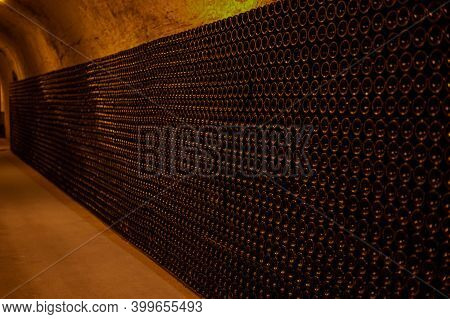 Champagne Grand Cru Sparkling Wine Production In Bottles In Rows In Dark Underground Cellars, Reims,