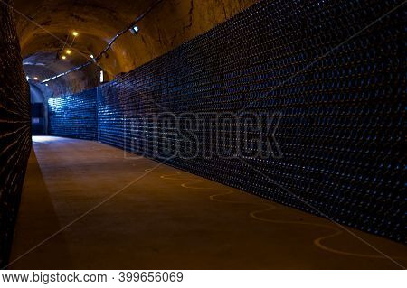 Champagne Grand Cru Sparkling Wine Production In Bottles In Rows In Dark Underground Cellars, Reims,